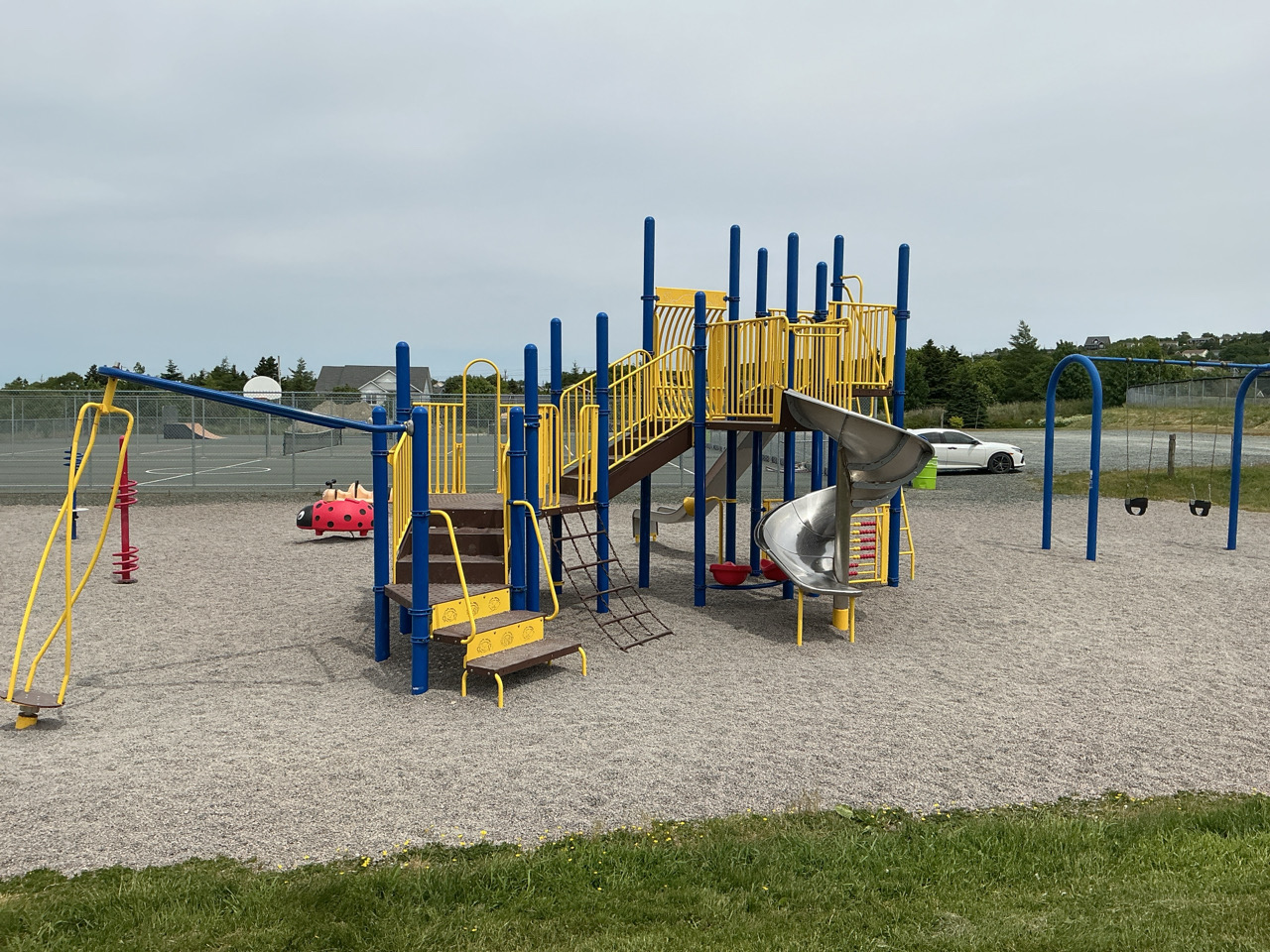 play structure with courts in the background